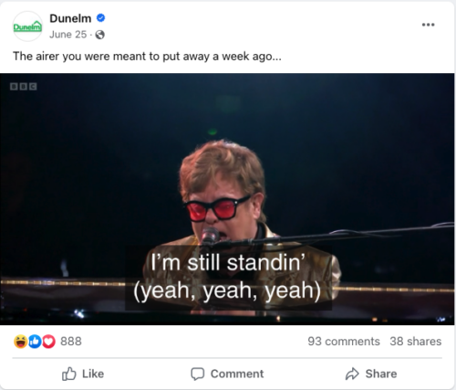 A post from Dunelm's Facebook page. Caption says:  “The airer you were meant to put away a week ago…” With a picture of Elton John with text overlayed that says “I’m still standing’ (yeah yeah yeah)”