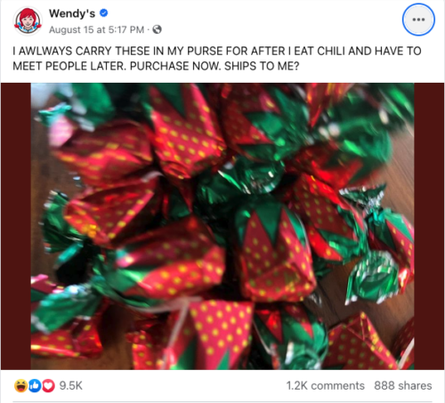 A post from Wendy’s Facebook page. The copy says: “I AWLWAYS CARRY THESE IN MY PURSE FOR AFTER I EAT CHILI AND HAVE TO MEET PEOPLE LATER. PURCHASE NOW. SHIPS TO ME?” (The spelling errors are deliberate.) There is also a blurry photo of some strawberry chocolate/sweets wrapped up. 